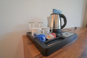 a coffee maker on top of a wooden table at The Trishul Vista in Mukteshwar