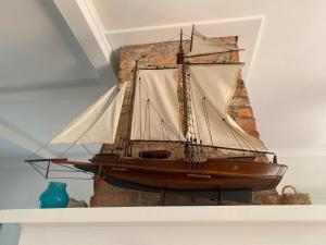 a wooden boat sitting on top of a shelf at Russell Waterfront Historic Cottage in Russell