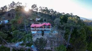 an aerial view of a house with a pink roof at The Trishul Vista in Mukteshwar