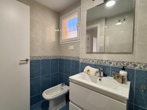 a bathroom with a sink and a toilet and a mirror at Apartamento Adelfa By Solymar Holiday in Benajarafe +68 photos