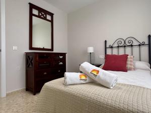 a bedroom with two beds and a dresser and a mirror at Apartamento Adelfa By Solymar Holiday in Benajarafe