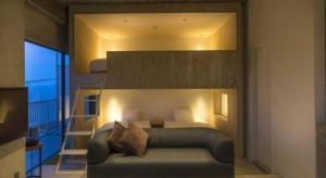 a bedroom with a bed and a staircase with a balcony at MISAKI TERRACE in Ako