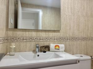 a bathroom with a white sink and a mirror at Apartamento Adelfa By Solymar Holiday in Benajarafe +34 photos