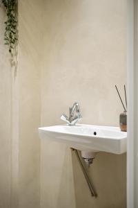 a bathroom with a sink and a white sink at Valby family apartment in Copenhagen