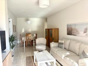 a living room with a couch and a table at Apartamento Adelfa By Solymar Holiday in Benajarafe