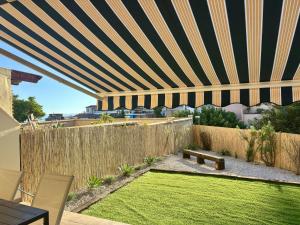 a backyard with a patio umbrella and a lawn at Apartamento Adelfa By Solymar Holiday in Benajarafe