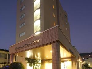 a large building with a sign on the front of it at Kamisuwa Station Hotel in Suwa