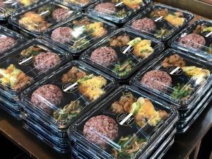 a display case filled with plastic containers filled with meatballs at The Orchid Hotel in Sibu +61 photos