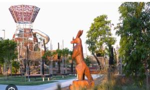 a statue of a giraffe in a park at Comfortable Home stay in Pimpama