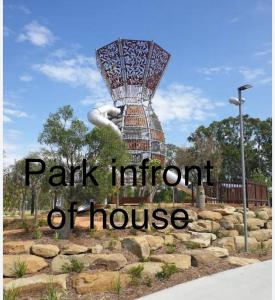 a park institution of house sign with a statue at Comfortable Home stay in Pimpama