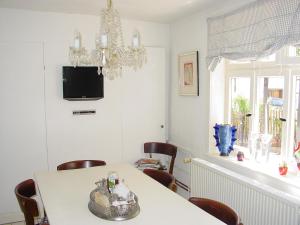 a dining room with a table and a chandelier at Robert's Bed & Breakfast in Helmarshausen