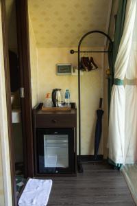 a room with a table and an umbrella in a room at Bamboo Hill Resort in Hữu Lũng