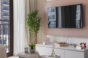 a living room with a mirror on a wall at F1 Chic Yas Studio Park Discounts! Near Yas Golf in Yas Island