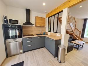a kitchen with a sink and a stove top oven at Gite Mirabelle in Moyenmoutier