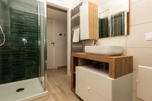 a bathroom with a sink and a glass shower at Il Nido dei Merli in Fiumicino +10 photos