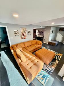 a large brown couch in a living room at Maxine Manor in Douglasville