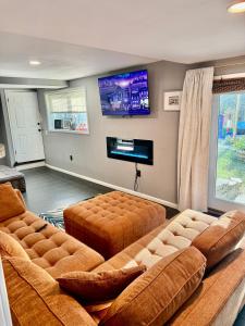 a living room with two brown couches and a flat screen tv at Maxine Manor in Douglasville