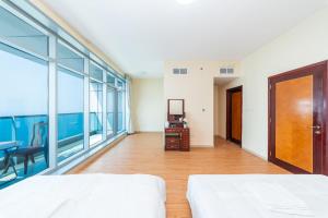 a large room with a bed and a mirror at Spacious 3BR Seaview Duplex Perfect for Families in Ajman  +47 photos