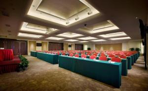 a large room with red chairs and desks in it at Xian Grand Soluxe International Hotel in Xi'an