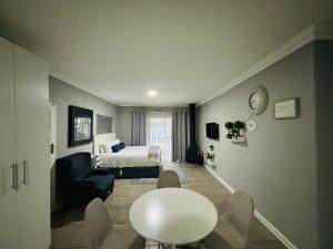 a hotel room with a bed and a table and chairs at Rolem Guest House in Fontainebleau