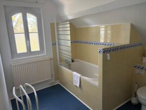 a bathroom with a tub and a shower and a toilet at Le Manoir de Conteville in Paluel +95 photos