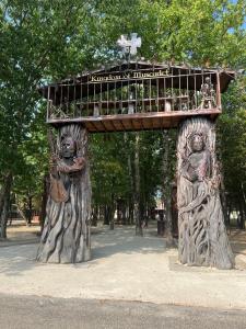 a wooden structure with a balcony in a park at Hotel Rivella - The Originals Boutique in Clisson +5 photos