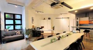 a large living room with a table and a couch at Silom Studios in Bangkok