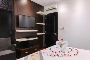 a bedroom with a bed with a dress on it at Khách sạn Le Domaine De Cocodo in Hue