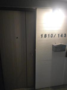 a door with a sign on the side of a building at BKK City & Airport Midpoint in Ban Khlong Bang Ping