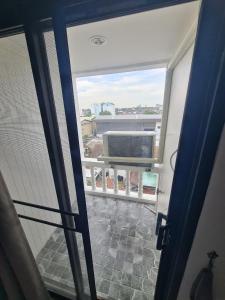 an open door to a balcony with a view at BKK City & Airport Midpoint in Ban Khlong Bang Ping