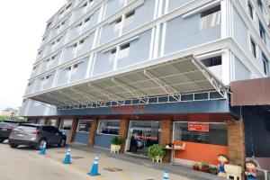 a large building with a parking lot in front of it at Station 203 Hotel in Bangkok