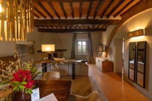 a living room with a dining table and a living room at Le Sorbelle D'Orcia in Pienza +89 photos