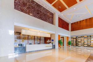 a lobby of a pharmacy with a counter in a building at Yihao International Hotel in Dongguan