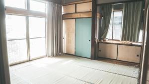 an empty room with large windows and a door at Kamui Kids House  +20 photos