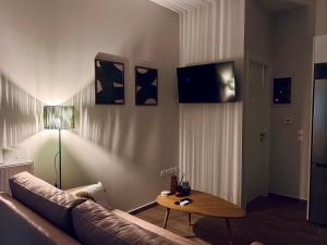 a living room with a couch and a table at Hodos Luxury APT 2 near ATH-Airport in Markopoulo