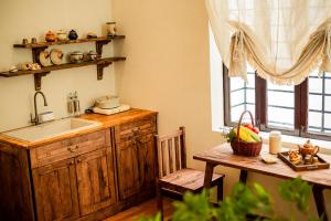 a kitchen with a sink and a table with a table sidx sidx at Nàng Homestay Studio in Thu Dau Mot
