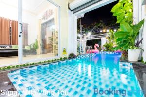 a swimming pool in the middle of a building at Villa Hồ Bơi Vũng Tàu Gần Biển - Sunny Villa 109 in Vung Tau