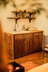 a kitchen with a sink and wooden cabinets at Nàng Homestay Studio in Thu Dau Mot