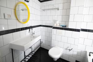 a bathroom with a sink and a toilet and a mirror at Dizengoff square boutique - aparthotel in Tel Aviv +13 photos