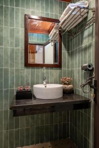 a bathroom with a sink and a mirror at Tam Coc Luxury Homestay in Ninh Binh +48 photos