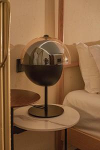 a mirror on a table next to a bed at Dali Mountain and Lake View Hotel in Dali Shuanglang
