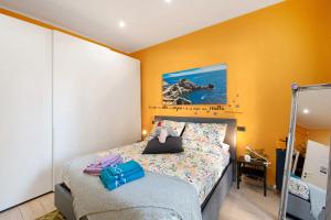 a bedroom with a bed and a painting on the wall at Oparavisegenova in Genova