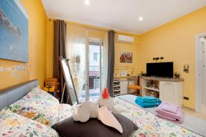 a bedroom with a bed with stuffed animals on it at Oparavisegenova in Genova