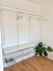 a room with white shelves and a potted plant at Krivoo Apartments III in Košice