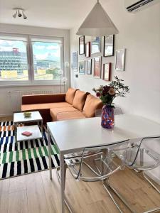 a living room with a couch and a table at Krivoo Apartments III in Košice