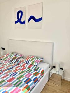 a bedroom with a bed with a colorful comforter at Krivoo Apartments III in Košice +2 photos