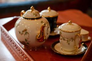 two tea cups and a tea pot on a table at Wusong Guyi Western Regions Designer Courtyard in Yining
