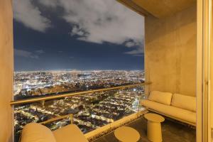 a living room with a view of a city at Luxury Penthouse with Jacuzzi & Views in Puebla