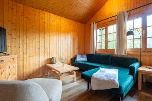 a living room with a couch and a table at Chalet Mon Reve in Blitzingen