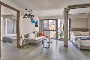 a bedroom with a bed and a couch and a table at Oakwood Studios Singapore in Singapore +44 photos